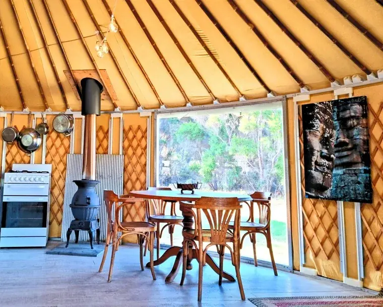 Interior of an 8m Yurt with fireplace and large windows