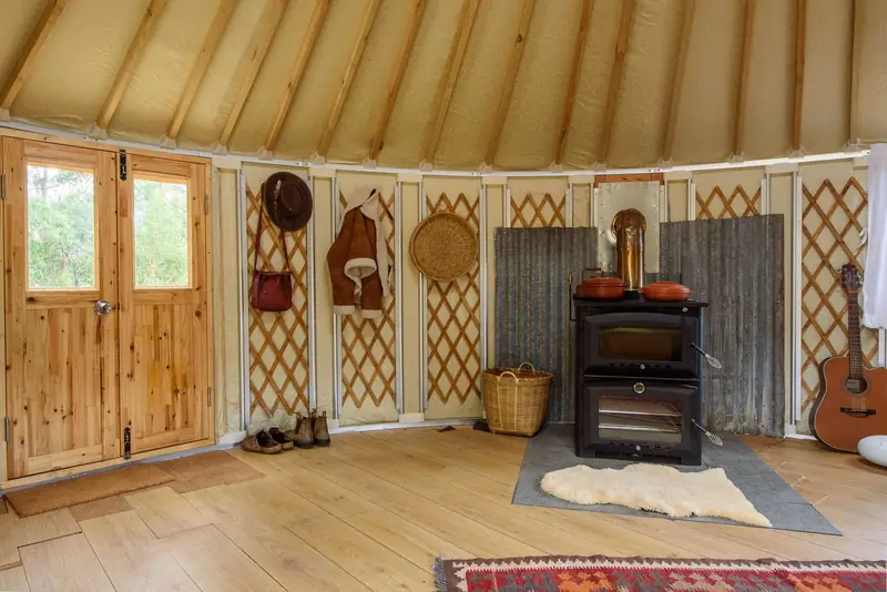 Wood heater warming an insulated yurt interior