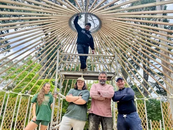 happy family building a yurt together